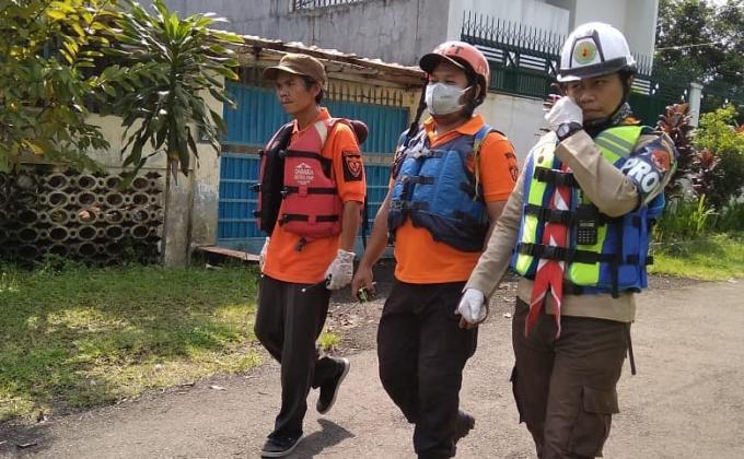 Members of Homeland Defense Special Unit and Rescue Teams Search for the Body of a Young Boy who Drowned in Ciliwung River