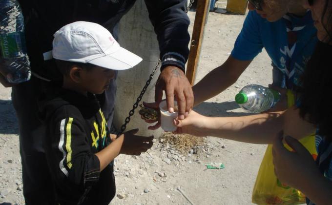 Visiting a refugee camp and donating food and water to the refugees