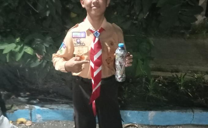 A scout holding his completed ecobrick