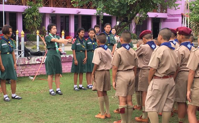 การฝึกสัญญาณ​มือสากล​โดย​พี่เลี้ยง​ลูกเสือ​โรงเรียน​ท่าม่วง​ราษฎร์​บำรุง​
