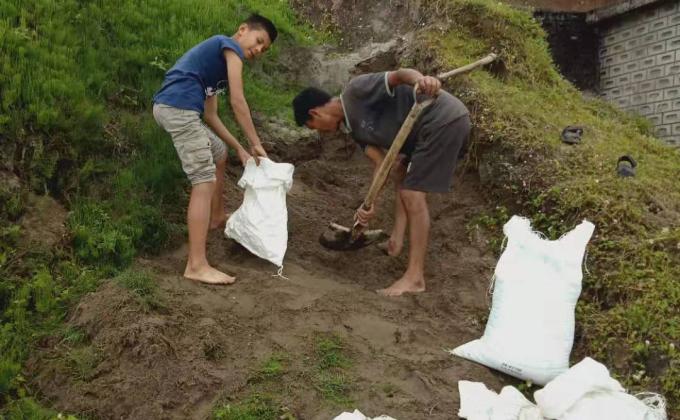 Carrying sand bags for school hand washing basin construction 