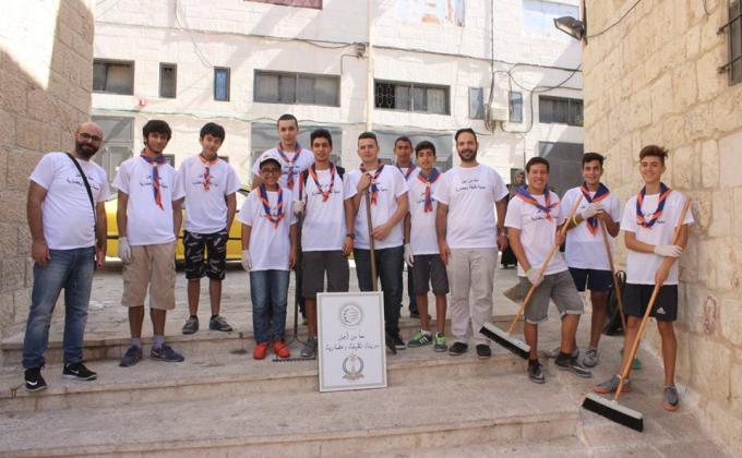 Scout members clean a historical monument 