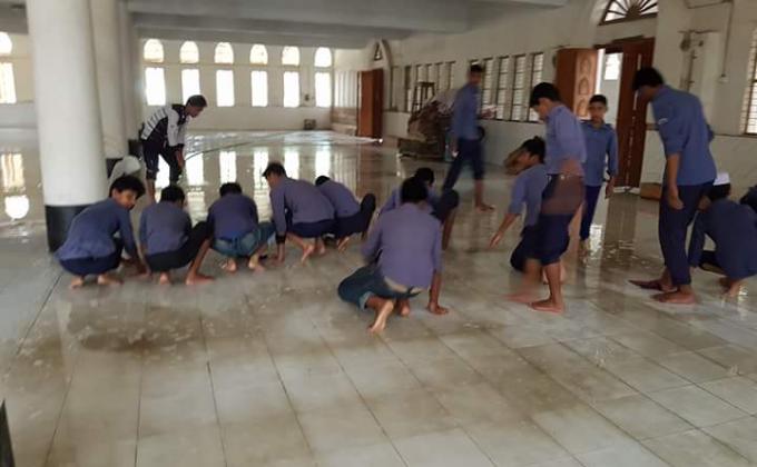 Washing the floor of a mosque by Scouts