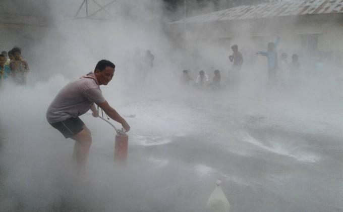 Demonstrating fire fighting techniques to scouts members...
