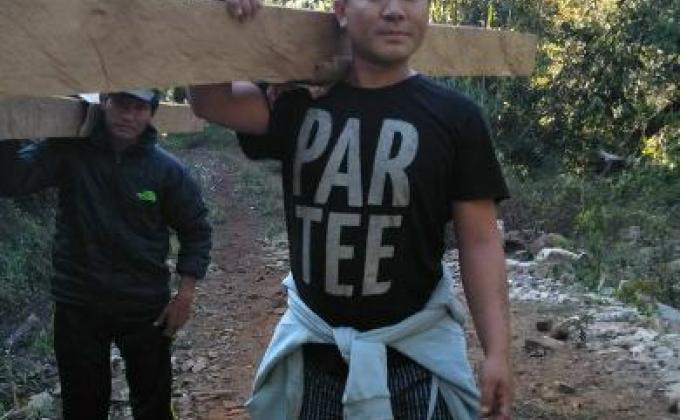 Nachung scout boys transporting wood.