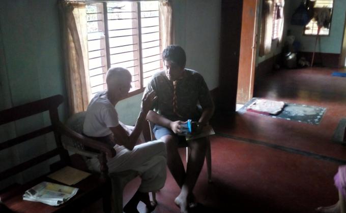 giving medicine to old man