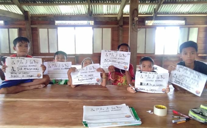 Teaching the indigenous Eskaya Scouts about their indigenous language and unique writing system. (BESO)