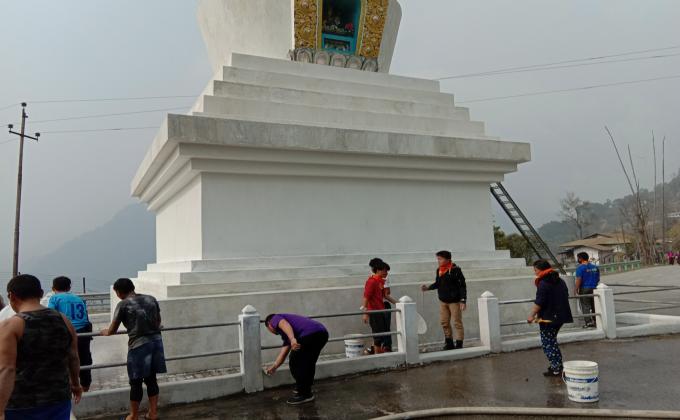 white washing the dewathang chorten