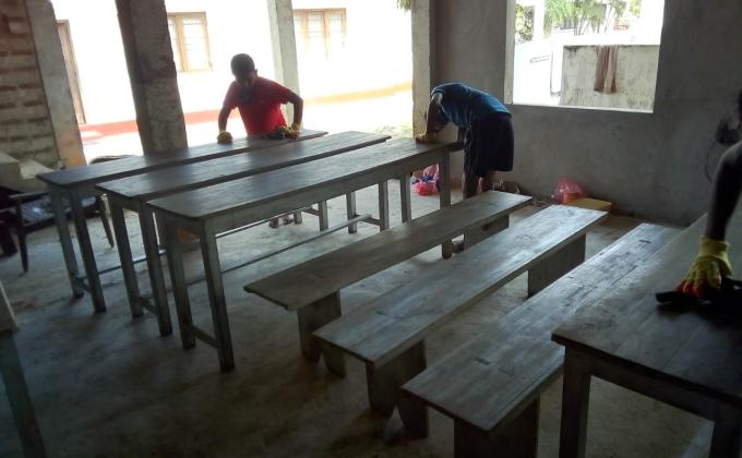 Refurbishing the Alms giving tables and benches polishing the Dhamma school chairs