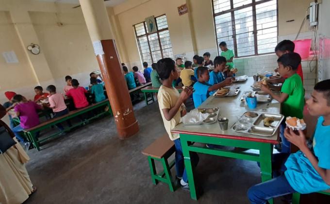 Sunday Morning at the Orphanage distributing food .