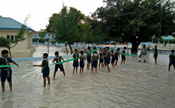 Scouts assisted to drain rain flood in school