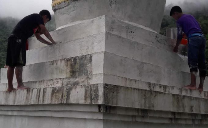 White washed a chorten (stupa).