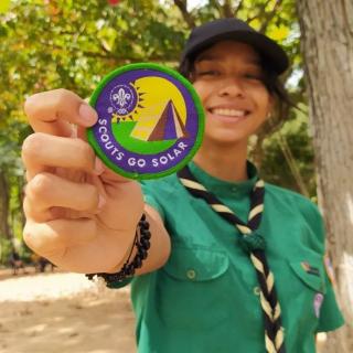 Oddete from Venezuela, showing proudly her Scouts Go Solar badge